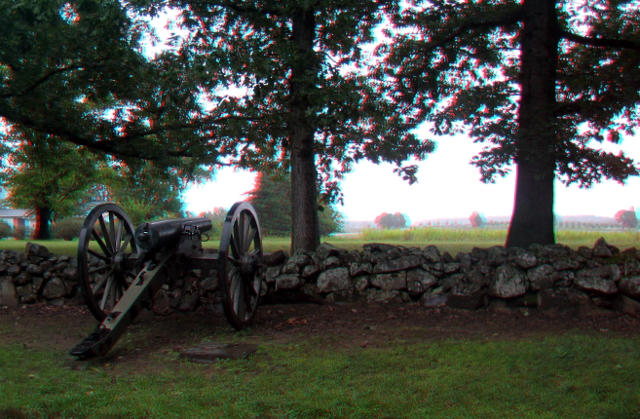 a cannon waiting behind a stone wall